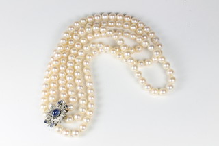 A triple rope of pearls with white gold clasp