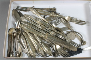 A pair of silver sugar tongs, 6 various silver tea spoons 3 ozs  and a collection of plated flatware