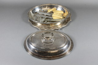 A circular silver plated salver with bracketed borders 12", an  oval entree dish and cover and a collection of fish knives and  forks