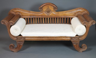 An Anglo Indian Regency style carved hardwood double scroll  end settee, fitted loose swab cushions raised on scroll feet 39"h x  76"l