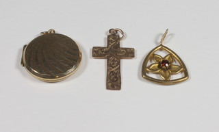 A gold cross and 2 gold pendants