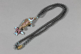 A Hematite bead necklace together with an articulated fish