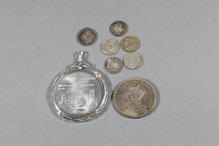 A 1976 silver Canadian silver crown to commemorate the Montreal Olympics, a 1975 Canadian dollar, a Victorian silver  fourpence and silver thruppences