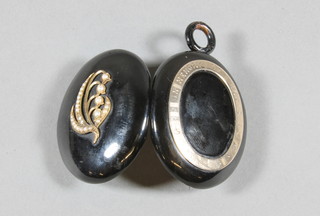 A 19th Century "jet" and gold mounted mourning locket set  demi-pearls and marked in Memory of Elsie, the interior fitted a  hair sculpture