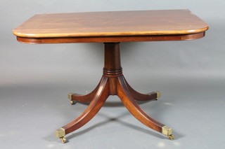 A late George III style mahogany triple pedestal extending  dining table, raised on cannon barrel supports, quadripartite base,  brass caps and casters, 30"h x 13'l x 4'