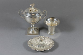 A silver twin handled trophy cup Chester 1868 with a non  matching plated lid, a Continental planished silver trumpet  shaped vase 3.5" and a modern silver embossed pin tray, 5 ozs