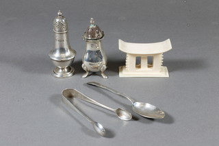2 silver pepperpots, a pair of silver sugar tongs, a silver spoon and a miniature Ashanti carved ivory stool 3"