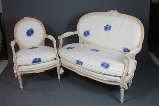 A French Louis XV style beech wood salon suite comprising 2  fauteuils and a 2 seat canape, having floral painted calico fabric  raised on turned tapered fluted legs