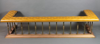 Robin Gage, a Regency style gilt brass club fender, having beige buttoned upholstered top, raised on plinth base 84"w x 18"h x  28"d  ILLUSTRATED