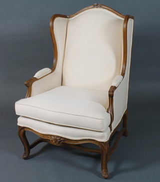 A French Louis XIV style carved walnut Duchess brisse  armchair, having reeded frames, raised on cabriole legs united by shaped stretchers, the ottoman 18"h x 28"w x 21"d
