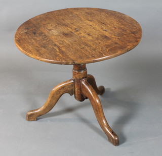 A George III oak tilt top tea table, the circular top raised on a tapered column support, tripod base, cut down, 23"h x 26"  diam.