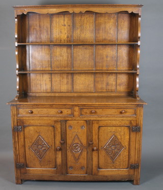 A mid 18th Century style oak high back dresser having a shaped  cornice above a 2 shelf panelled back, 2 frieze drawers with 2  lozenge carved cupboard doors below, raised on end stiles 73"h x  54"w x 19"d