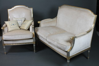 A Louis XVI style silvered and parcel gilt salon suite, comprising a 2 seat canape and 2 fauteuils