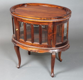 An 18th Century style mahogany bijouterie table of oval drum  form with removable tray top, fitted glazed door to side, raised  on cabriole legs 31"h x 30"w x 20"d