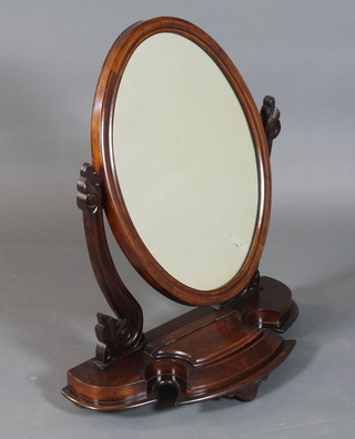 A Victorian mahogany toilet mirror having oval plate with scroll carved supports, fitted trinket box to base, on scroll feet 31"h x  25"w x 11"d