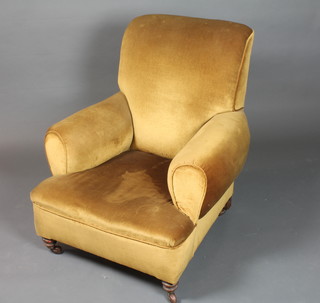 A Victorian armchair upholstered in gold dralon, on turned feet