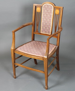 An English Art Nouveau mahogany elbow chair with part padded  back decorated with marquetry roundels of Saxon style longboats,  raised on square tapered legs spade feet