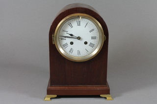 An Edwardian mahogany mantel clock, having an arched top  case, set Roman enamelled dial and 8 day cylinder movement striking bell, signed Harrison & Son Paris, raised on brass  bracket feet 10.5"h x 8"w