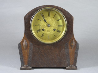 A 1930's oak mantel clock with later dial and movement signed Rollin, Paris with foliate engraved Roman dial with outer minute  track, the 8 day movement striking bell 10.5"h x 10"w