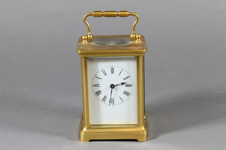 An early 20th Century French gilt brass carriage timepiece having Roman enamelled dial and 8 day movement with lever  escapement, 6"h x 3"w x 3"d