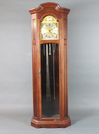 A French reproduction walnut longcase clock in the 18th Century  style having a broken arch topped brass dial with silvered Roman  chapter ring, set quarter repeating movement with Whittington,  St Michael and Westminster chimes on gongs 77"h x 26"w x  15"d