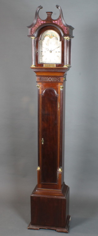 An early 20th Century mahogany longcase clock of diminutive  size in the mid 18th Century style, having an 8" broken arch  silvered Roman dial with moon phase decorated maritime scene  and chateau, set 8 day movement, chiming gong. The case with  moulded broken swan neck pediment above a blind fret cut frieze  and fluted column supports, the trunk with arched top door  flanked by fluted quarter pilasters, raised on a box base with  block feet, bears inscribed brass plaque 79"h x 13"w x 10"d   ILLUSTRATED