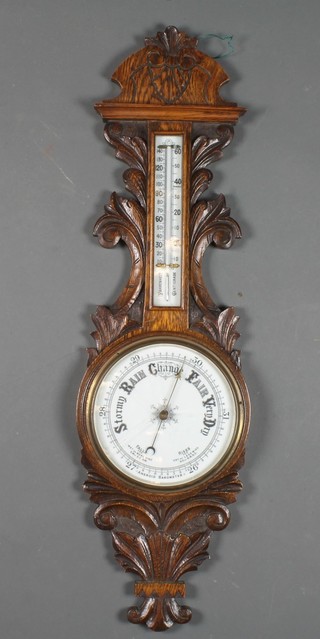 A late Victorian carved oak aneroid barometer having Arabic  enamelled thermometer and calibrated dial 35"h x 10.5"w