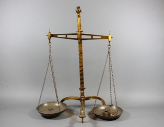 A pair of brass scales by Andome & Co London with weights