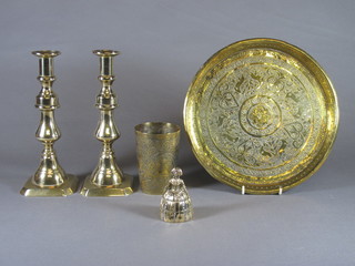 A brass table bell in the form of a crinoline lady 3", pair of 19th Century brass candlesticks with ejectors 9", a Benares brass tray  10" and a do. beaker 4"