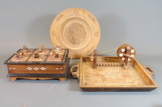 A 6 section hardwood box the lid decorated frogs 10", a carved  Moorish style square twin handled tray 12", a model wool winder  and a circular platter