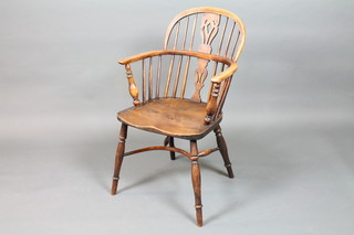 An elm, ash and yew wood high back Thames Valley Windsor  chair, circa 1840, having pierced and shaped vase splat, saddle  seat, raised on ring turned legs united by a crinoline stretcher