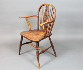 A 19th Century Thames Valley beech wood and elm wheel back  chair, having a shaped and pierced splat above a saddle seat on  ring turned tapered legs, united by H stretcher