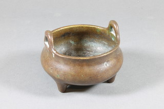 A Chinese bronze twin handled incense sensor, raised on 3 feet,  the base with seal mark 3.5"
