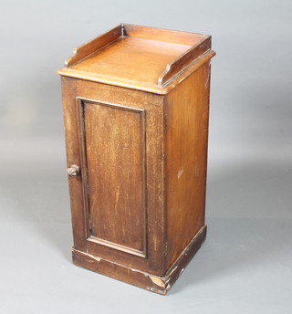 An early Victorian mahogany pot cupboard having a  three-quarter galleried top, fielded panelled cupboard door on  plinth base 32.5"h x 15".5w x 15"d