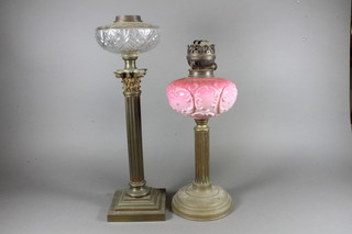 A Victorian opaque glass oil lamp reservoir raised on a reeded column with Corinthian capital together with a Victorian pink  glass reservoir raised on a reeded base