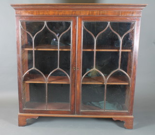 A George III mahogany bookcase having moulded cornice above  a pair of arch bar glazed doors enclosing 4 adjustable shelves,  raised on shaped bracket feet, formerly the upper section of a  bureau bookcase, 53"h x 52"w x 15"d