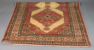 A Caucasian style rug with 2 diamonds to the centre within  multi-row borders 84" x 59"