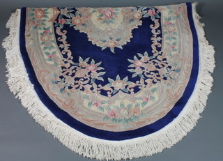 An oval blue ground and floral patterned Chinese rug 101" x 59"