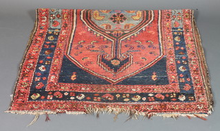 A Persian rug with central medallion within multi-row borders  67" x 41"