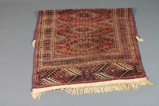 A red ground Afghan rug with 4 octagons to the centre within  multi-row borders 53" x 35"