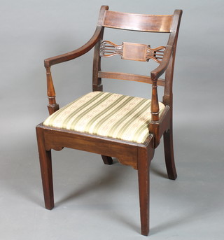 A late George III mahogany elbow chair having tablet cresting rail and spar, reeded arms above a drop in seat raised on square  legs