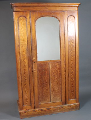 A late Victorian pitch pine single door wardrobe with moulded cornice above a glazed door enclosing 5 linen shelves and 2  drawers, raised on plinth base 82.5"h x 49"w x 23"d