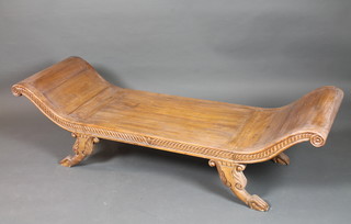 An Eastern carved hardwood day bed in the Regence taste with gadroon carved decoration, raised on foliate carved splayed legs,  claw and ball feet 72"l x 21"d
