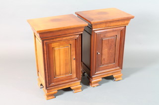 A pair of early 19th Century French style stained beechwood bedside cupboards, having moulded tops above fielded panelled  cupboard doors, raised on ogee bracket feet 28"h x 17.5"w x  13.5"d