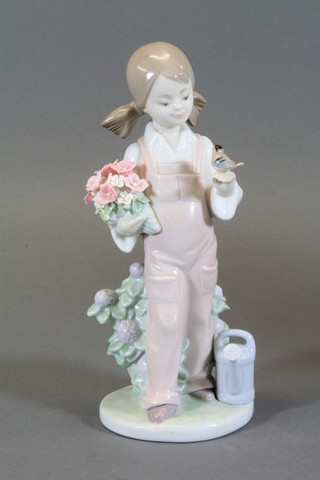 A Lladro figure of a standing girl with watering can, base marked 5217 7"
