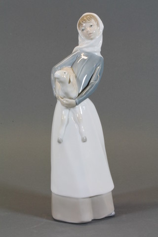 A Lladro figure of a standing girl with lamb 10"