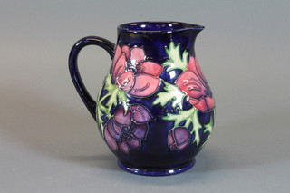 A Moorcroft blue glazed jug decorated anemone, base impressed Moorcroft and marked SJW and 3494 6"