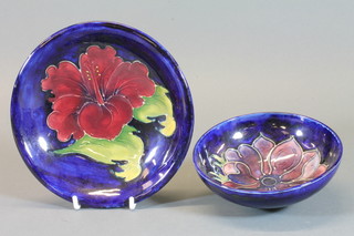 A Moorcroft circular blue glazed dish decorated a hibiscus and anemone 7.5" and a do. bowl 5"
