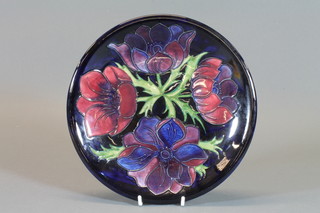 A Moorcroft blue glazed charger decorated anemone, base  marked GN 10"