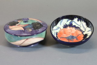 A Moorcroft circular bowl and cover decorated tulips, base  impressed Moorcroft, a candlestick 4" and a circular bowl marked 96 4"